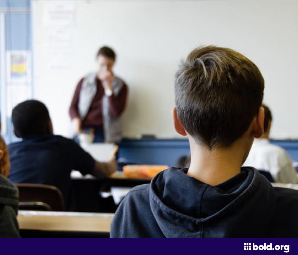 Students looking at a white board in a classroom