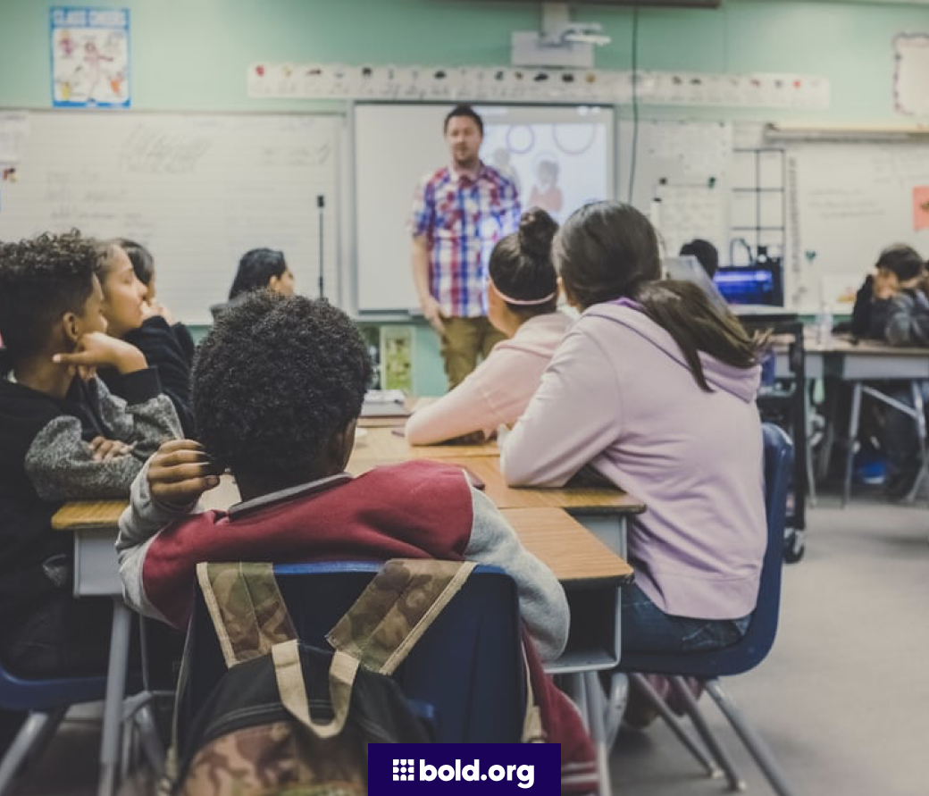 Students at a table in a classroom.