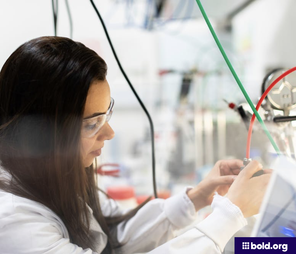Woman in safety glasses working in a lab