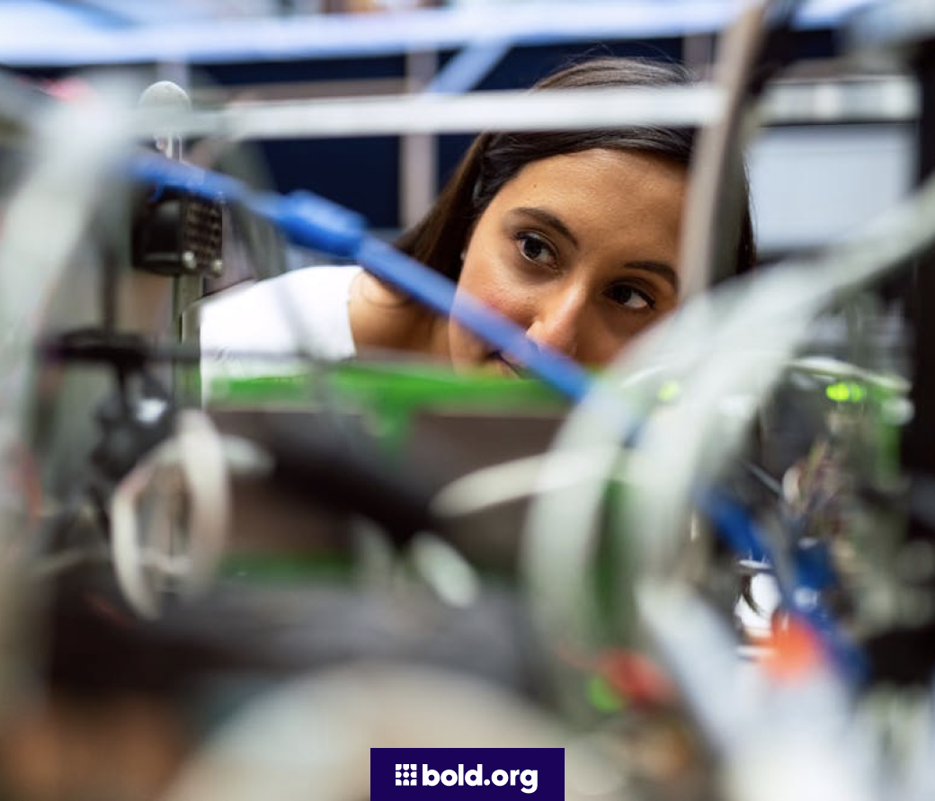 Woman examining the wiring in a lab