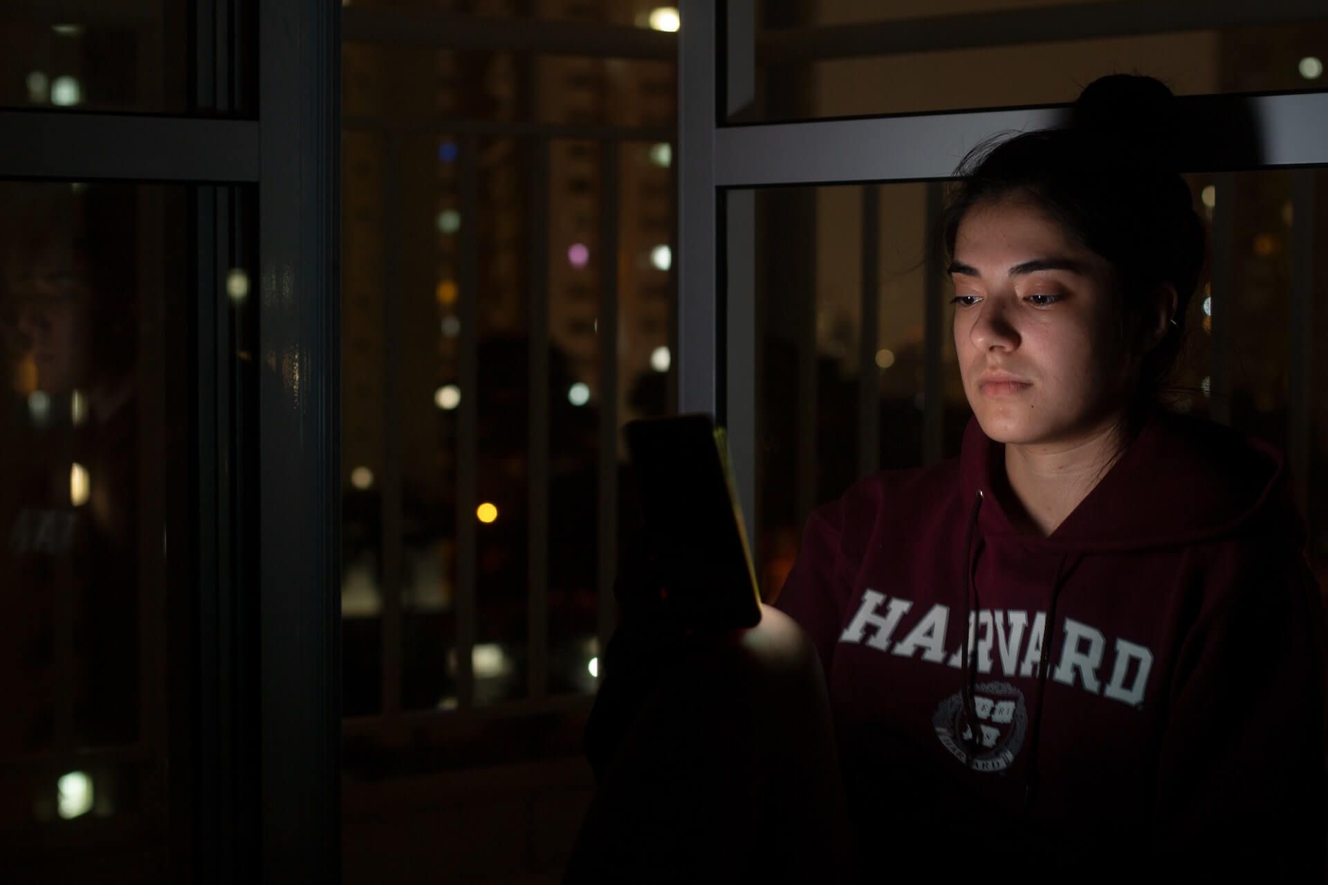 a college student wearing harvard university sweater