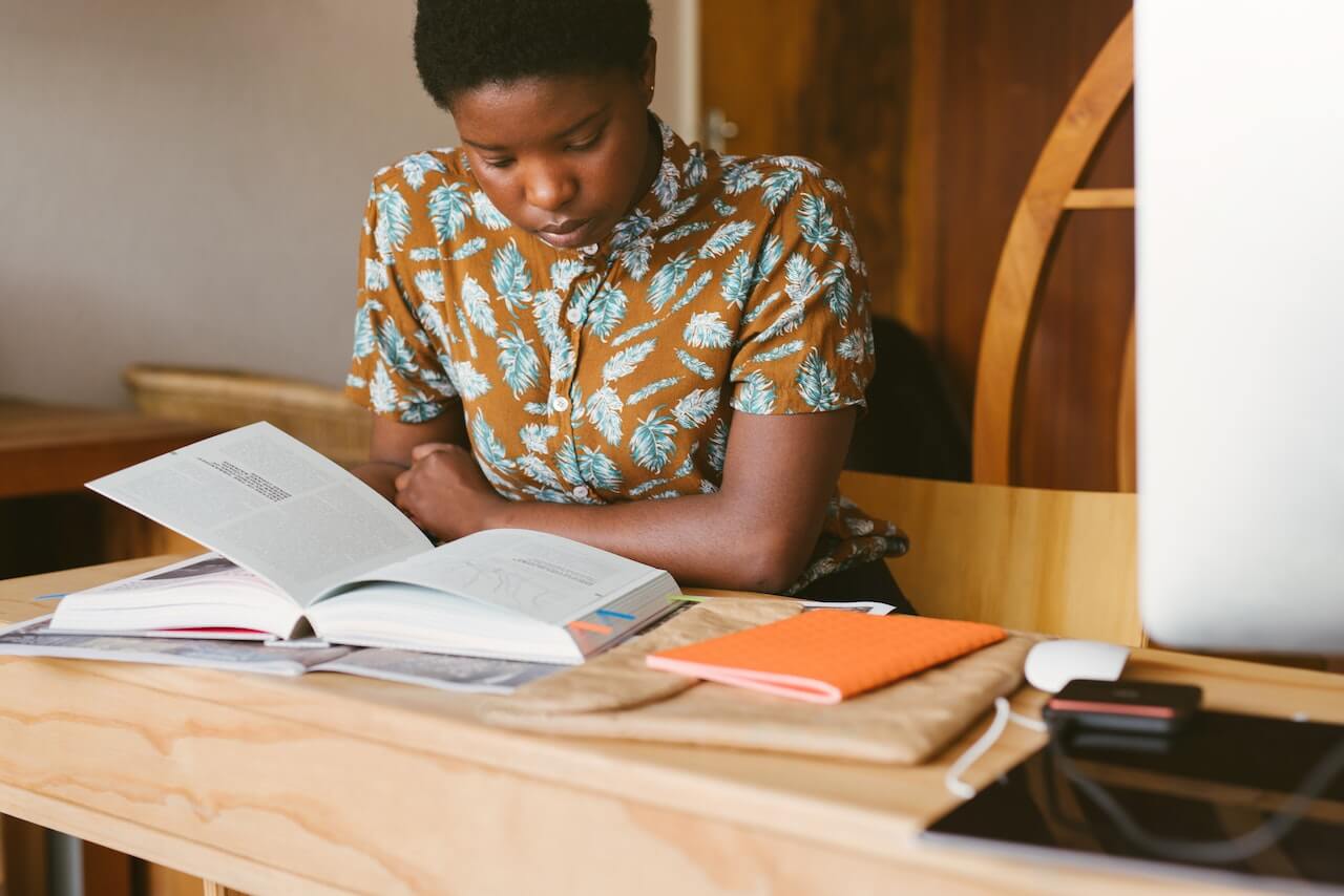 Student reading an SAT preparation book