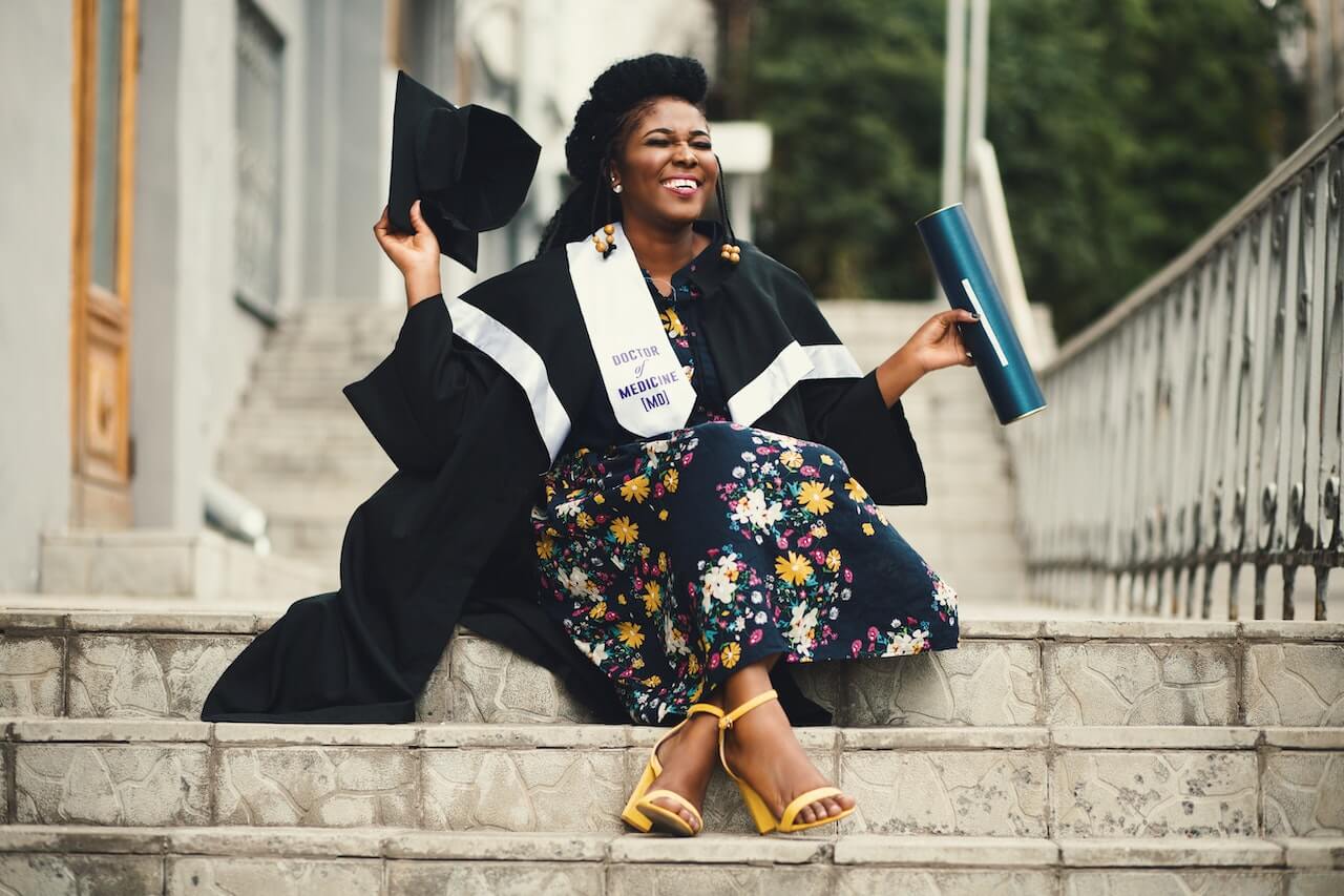 grad student sitting on stairs and smiling