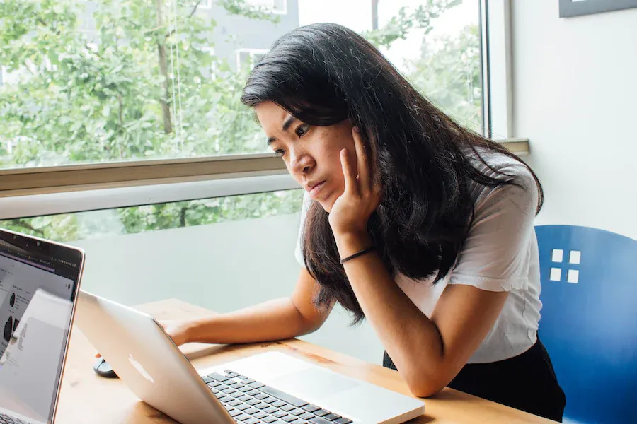 female student works at laptop