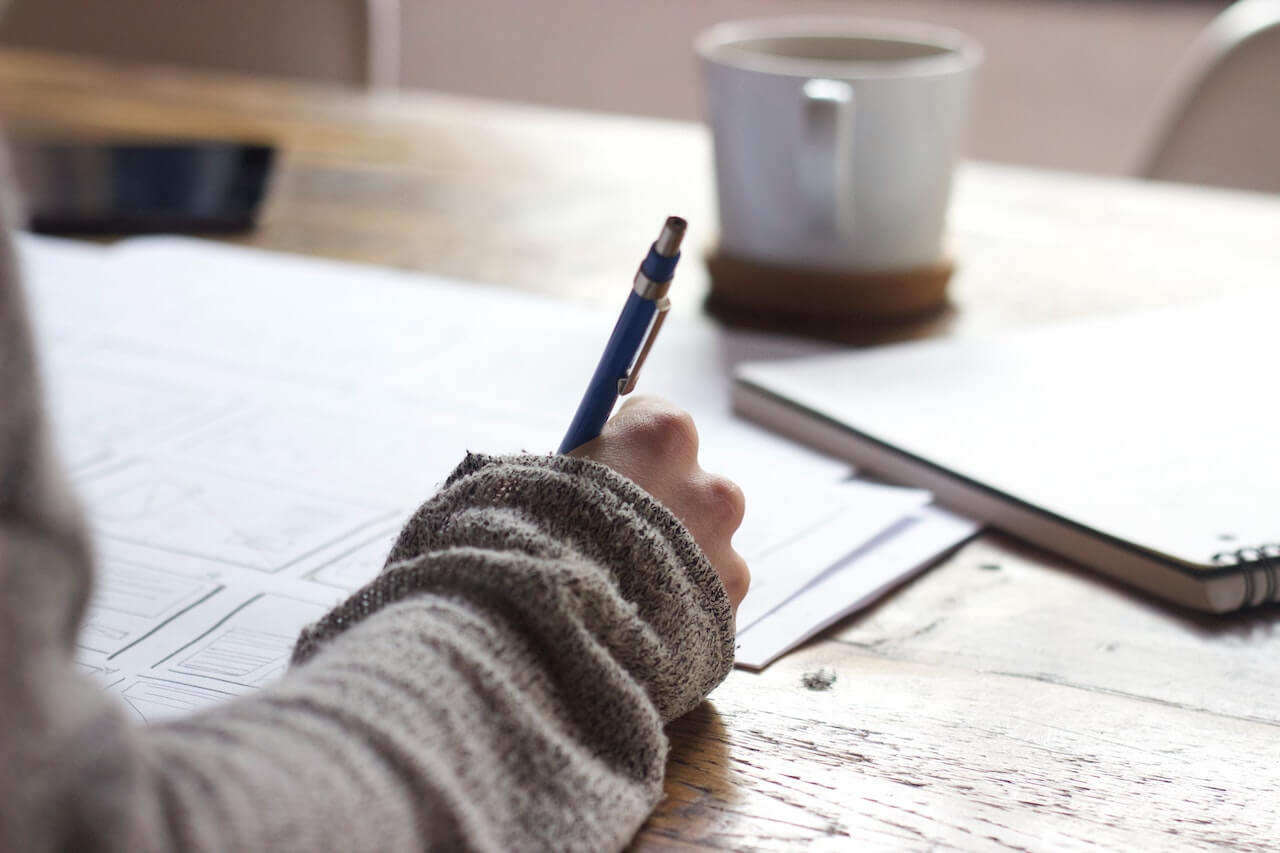 college student takes notes and applies for scholarships