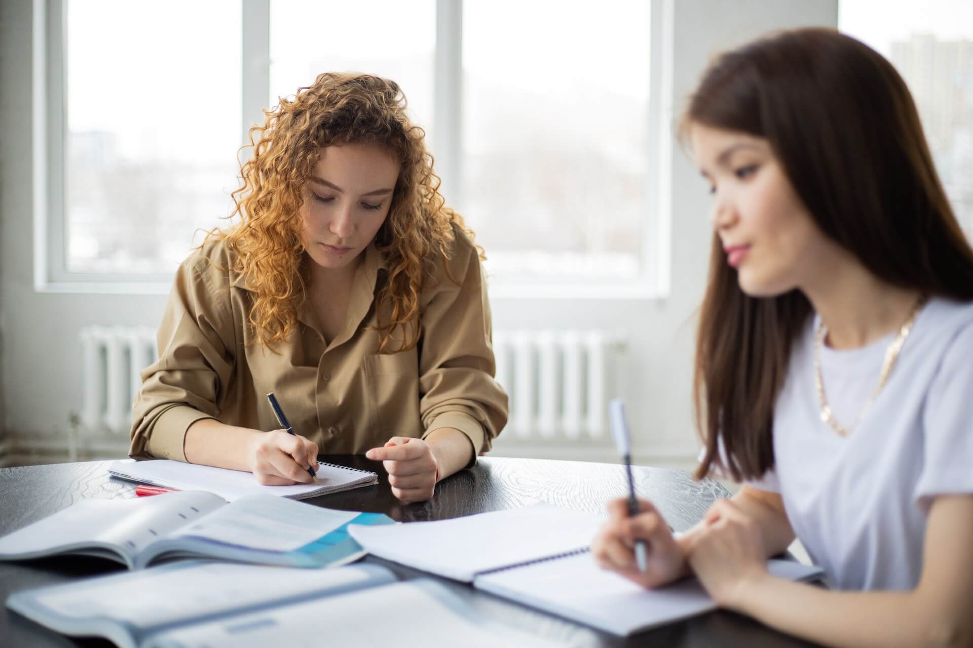 Students working on essays together at a table