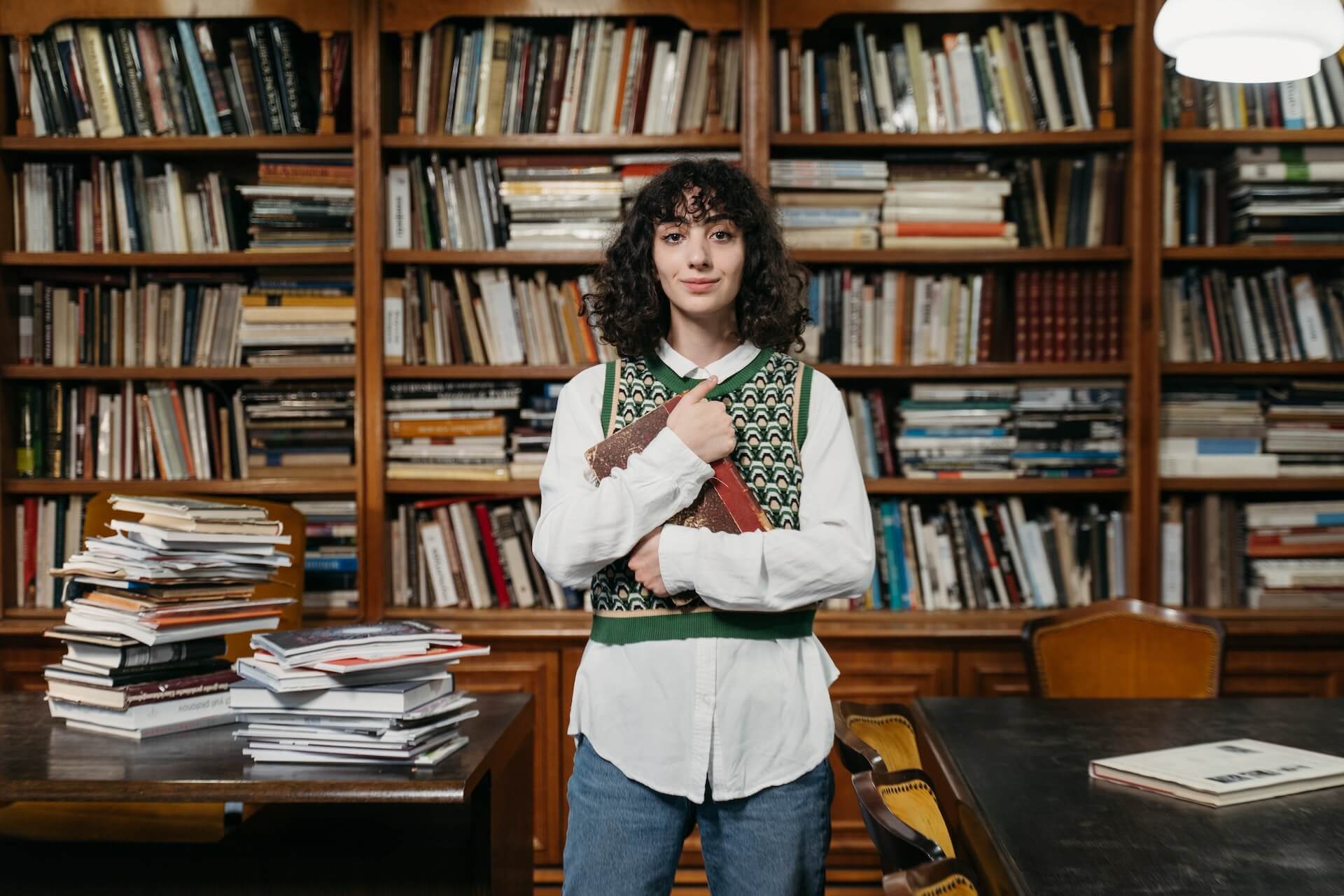 Female student holding a book in the library