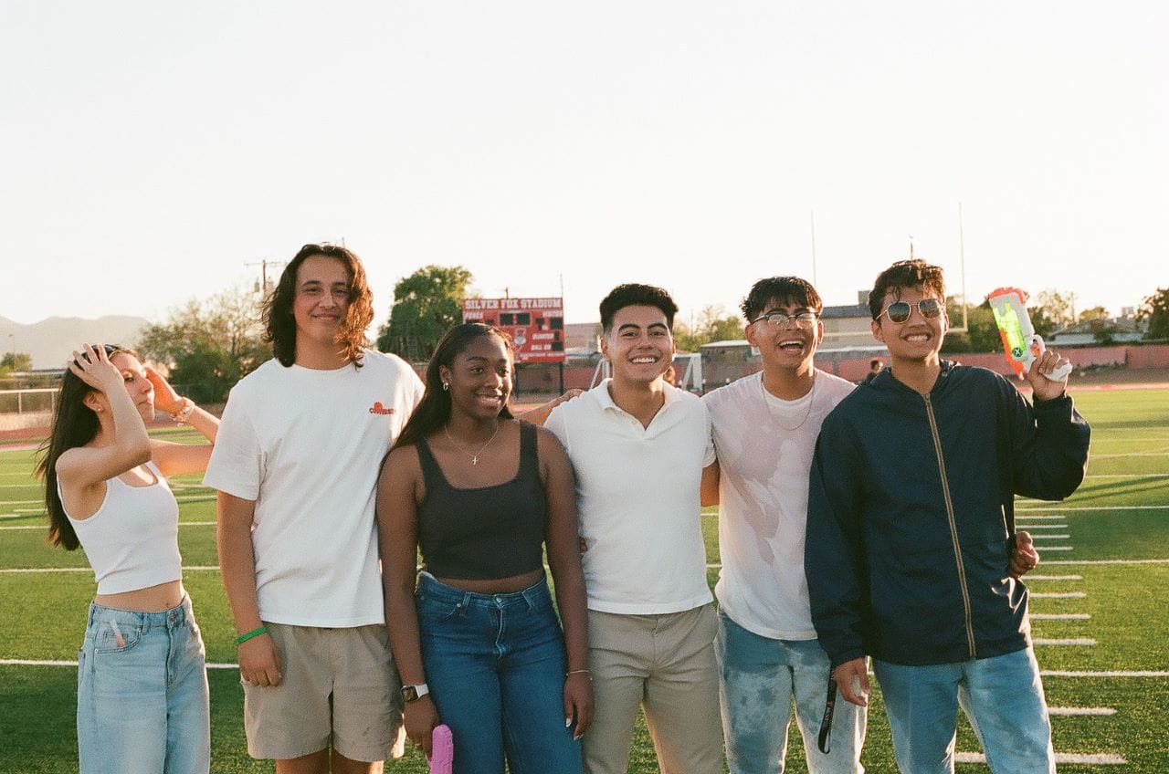 students in grad school on football field