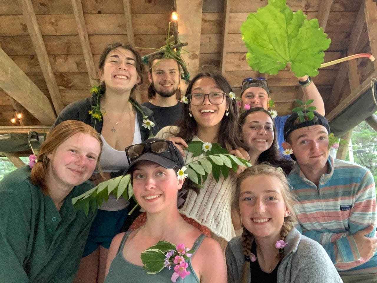 students posing for a photo with plants