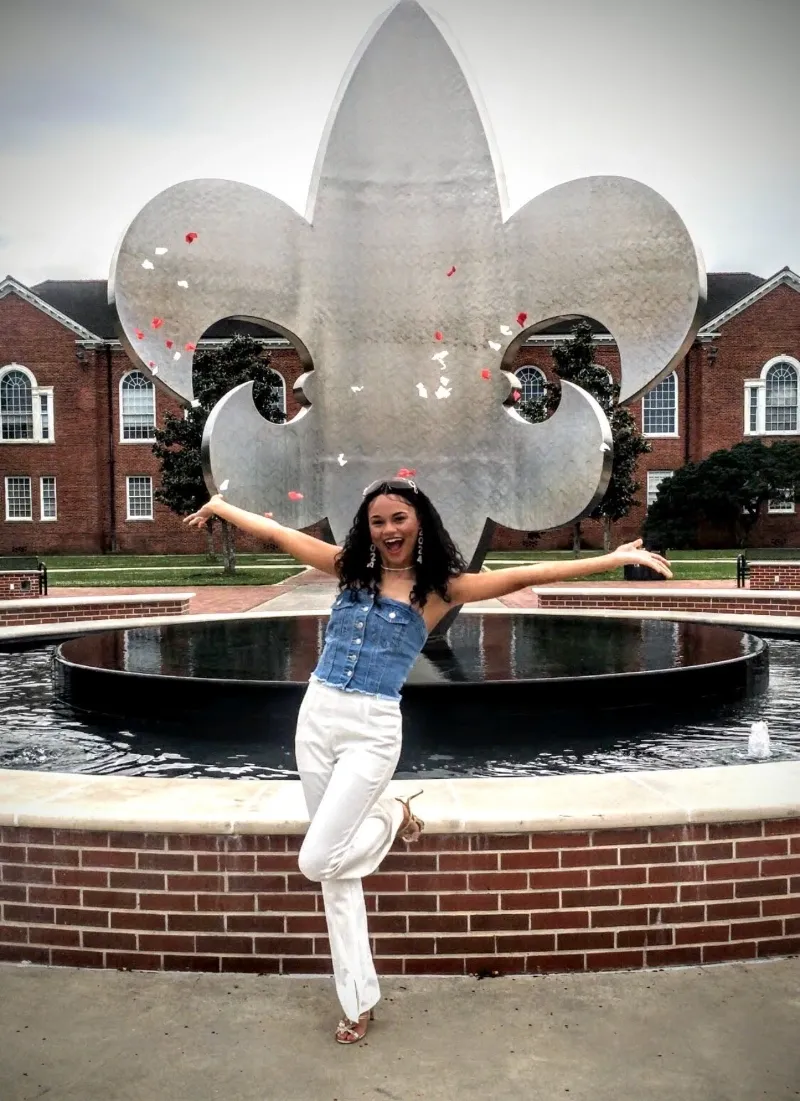 SUNY student in front of water fountain