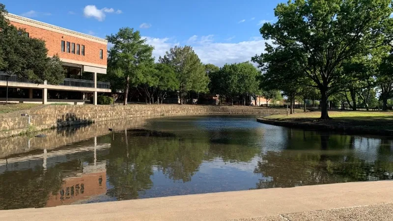 private college campus with a lake