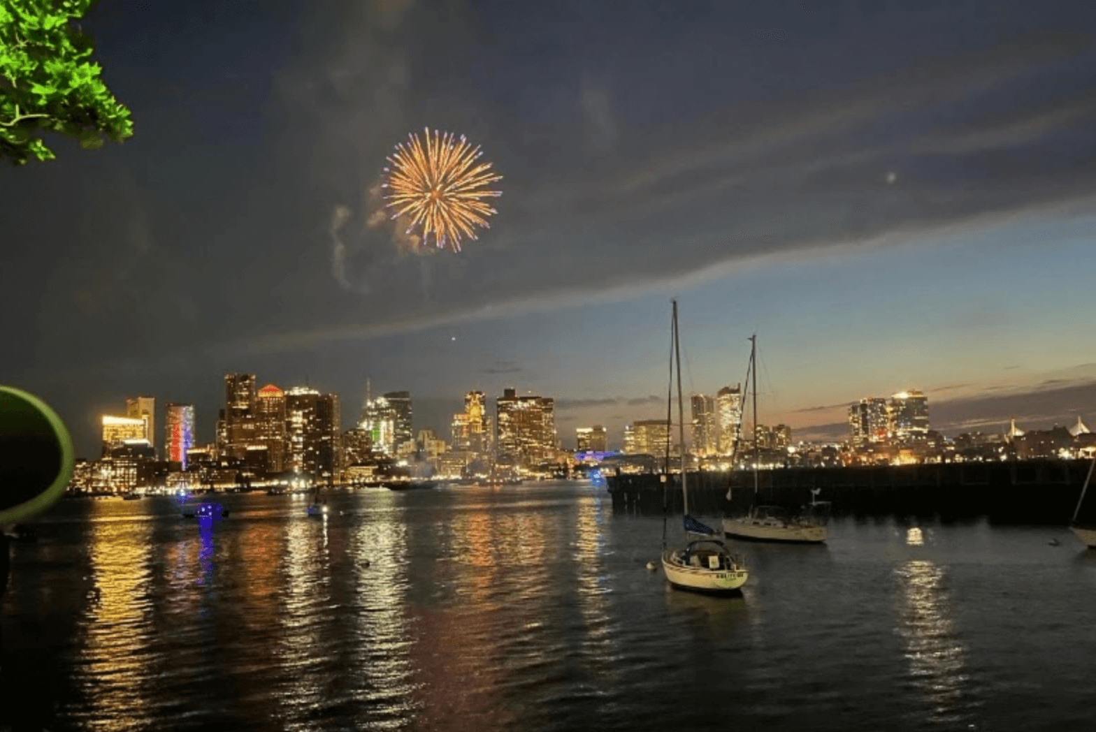 city harbor with fireworks and fishing boats