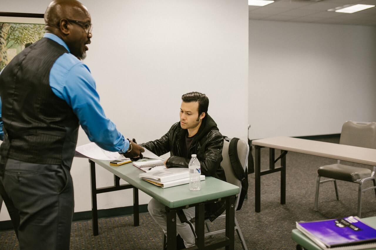 student attends college lecture for professor feedback