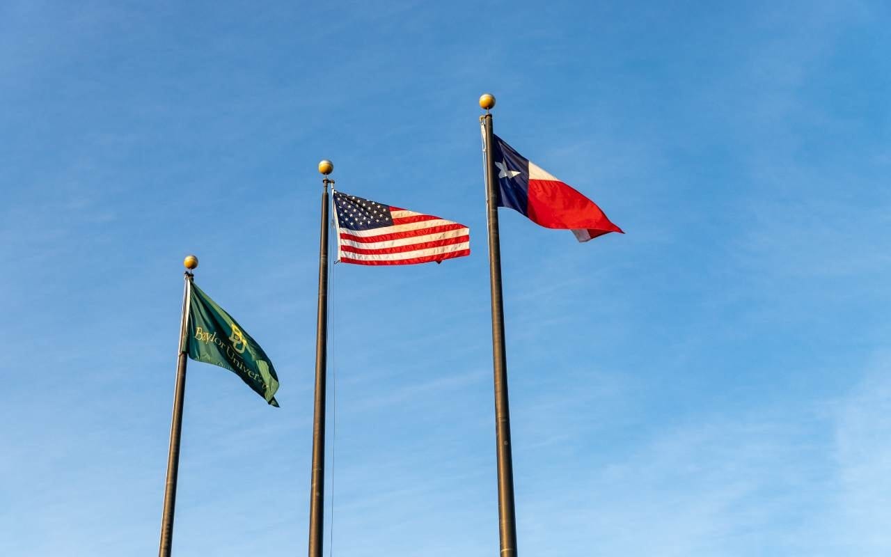 American and texas flags on blue sky