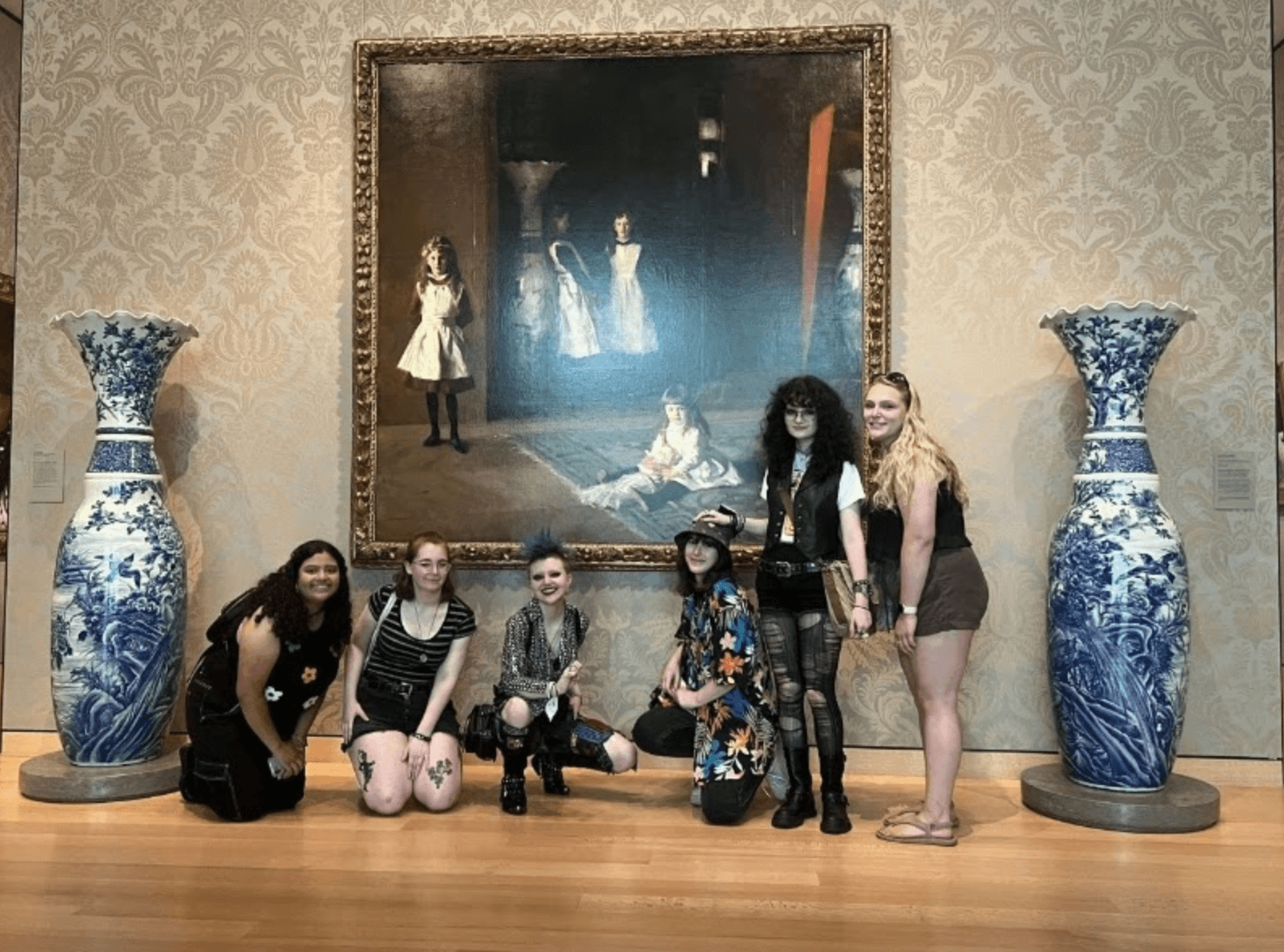 art students visit classical paintings and vases in a museum