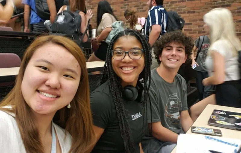 diverse students smiling in lecture hall