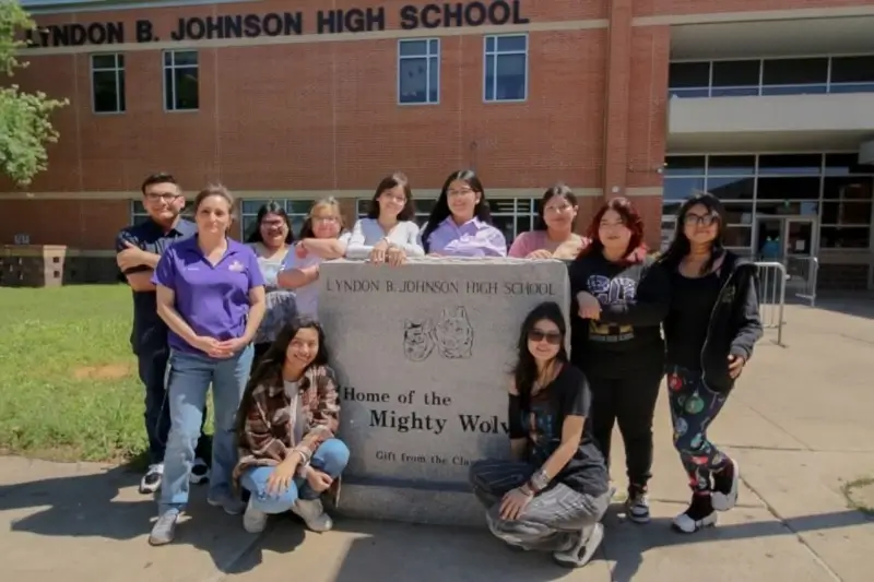 students gather in front of high school