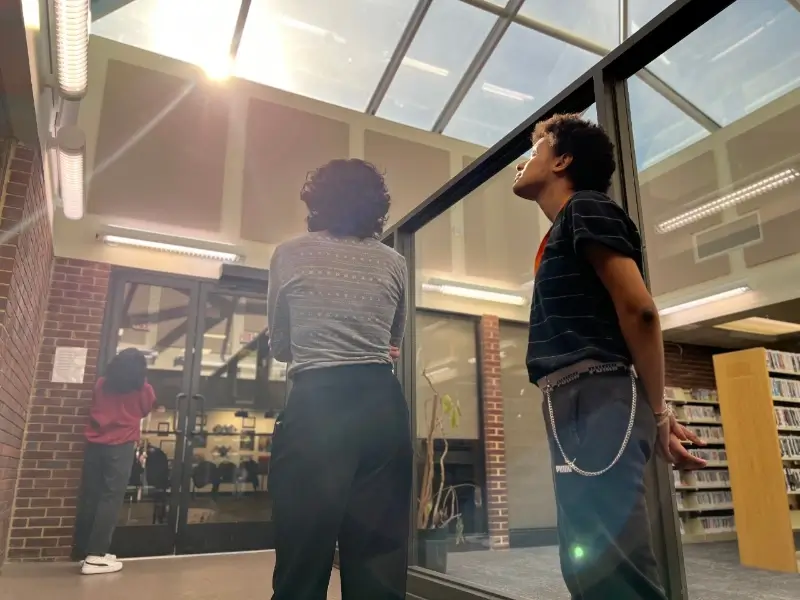 three students in a california community college library