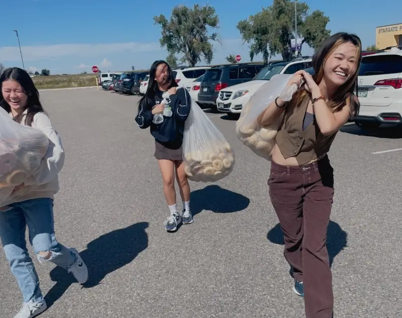 students carry bags of bagels for after-school job