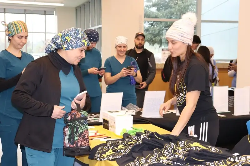 school volunteers sell t-shirts