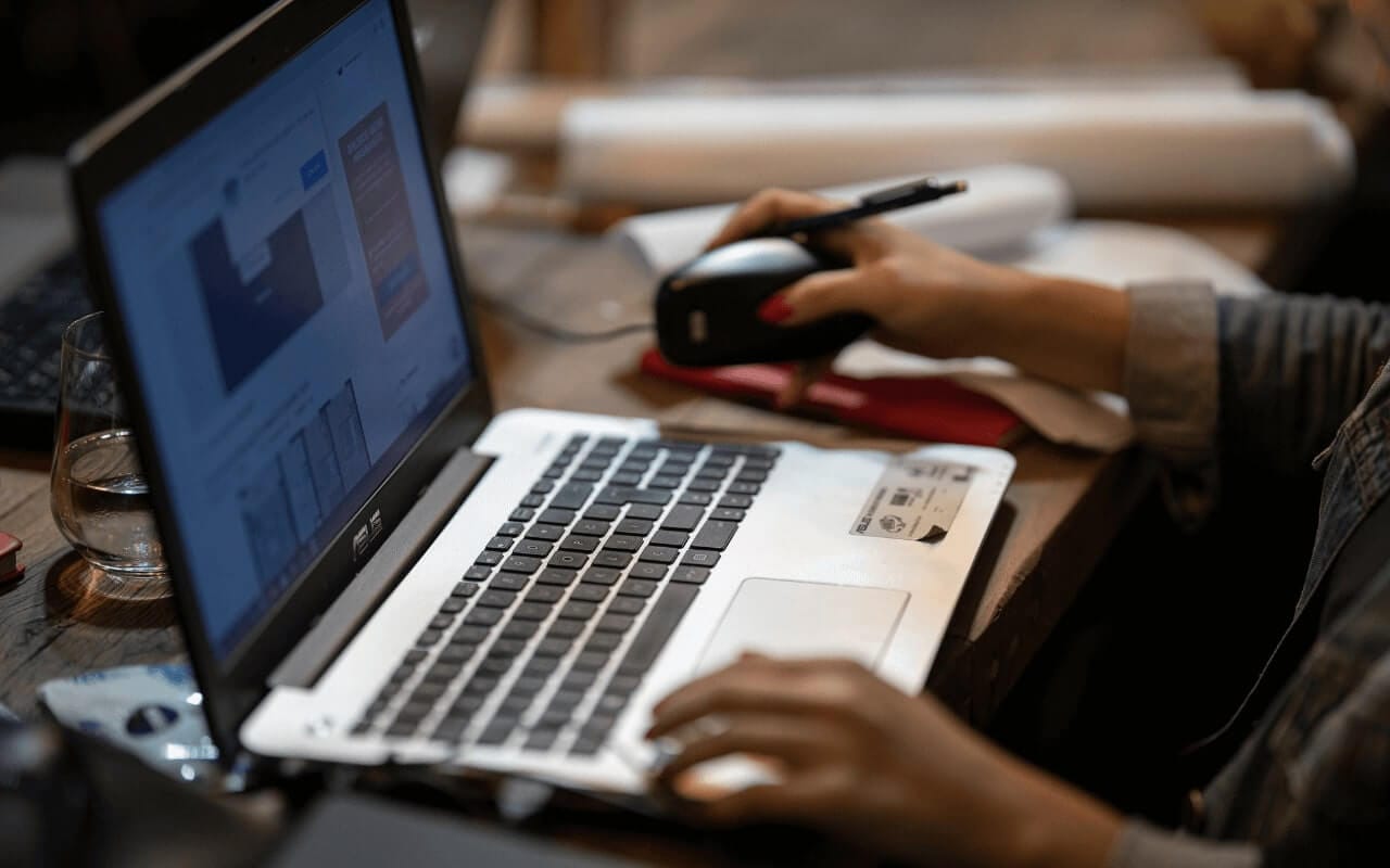 student researches assignment at laptop