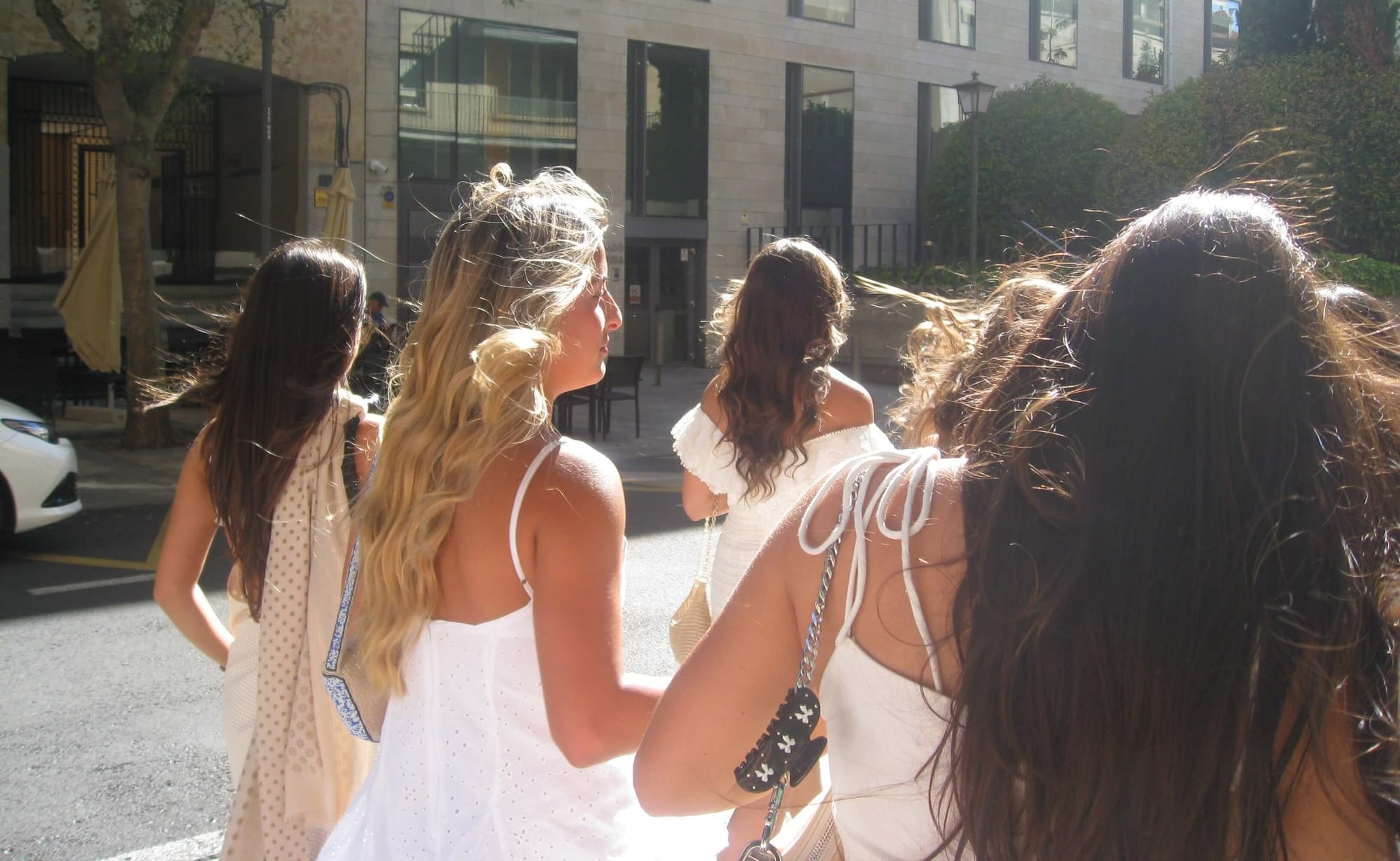 students in white dresses enjoy the sun over spring break