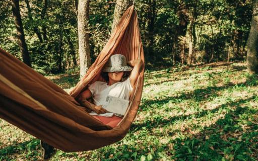 student relaxes in a hammock over spring break